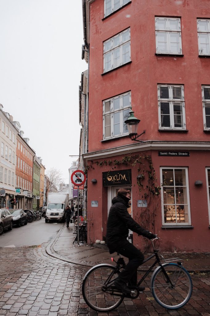 Photo of a cyclist in Copenhagen, Denmark, during a snowy day in winter