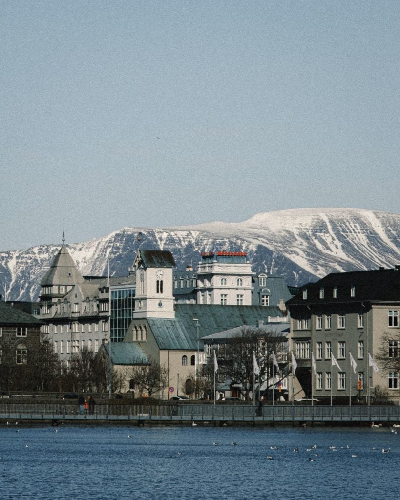 view of reykjavik from tjornin lake