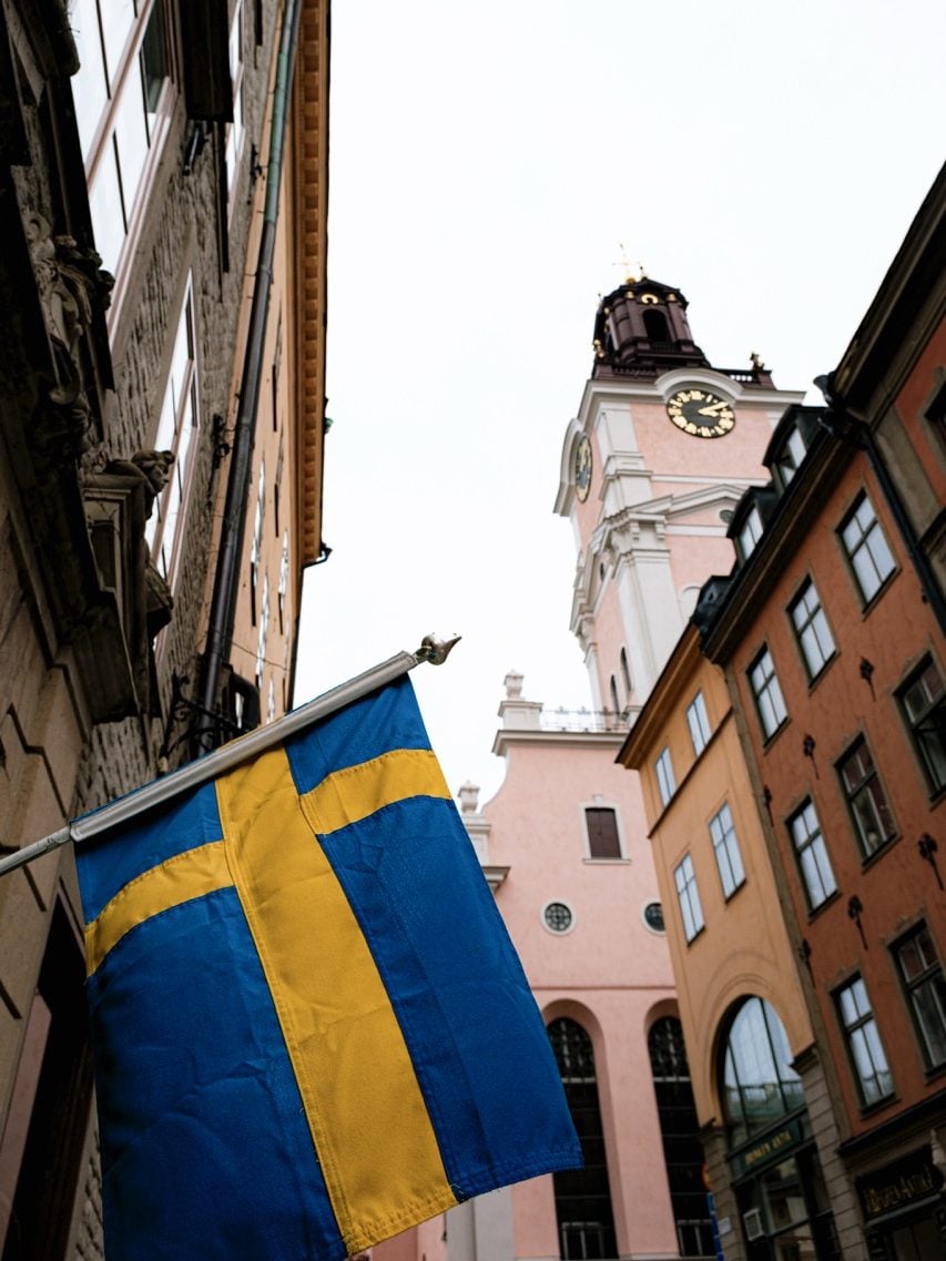 A Swedish flag next to a church in Stockholm
