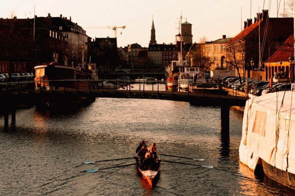 People kayaking on the water in Copenhagen on a spring evening