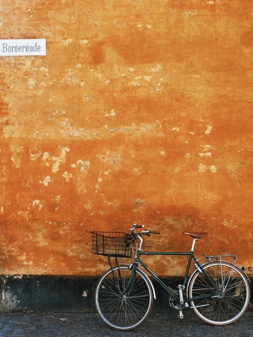 A bike outside an orange house in Copenhagen