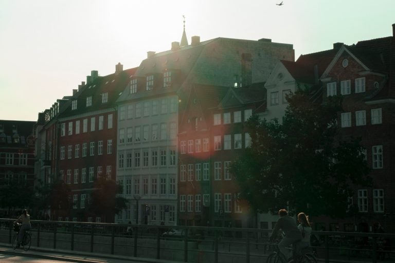 A couple cycling in Copenhagen during the summer