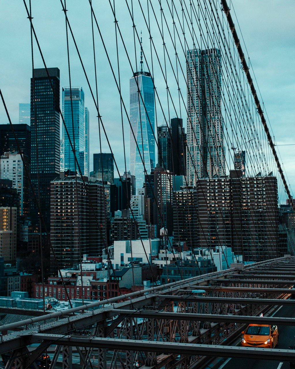 A view from the Brooklyn Bridge of a taxi and the Financial District