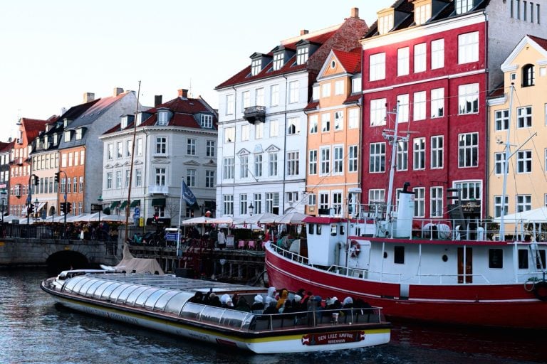 A boat passing through Nyhavn in Copenhagen