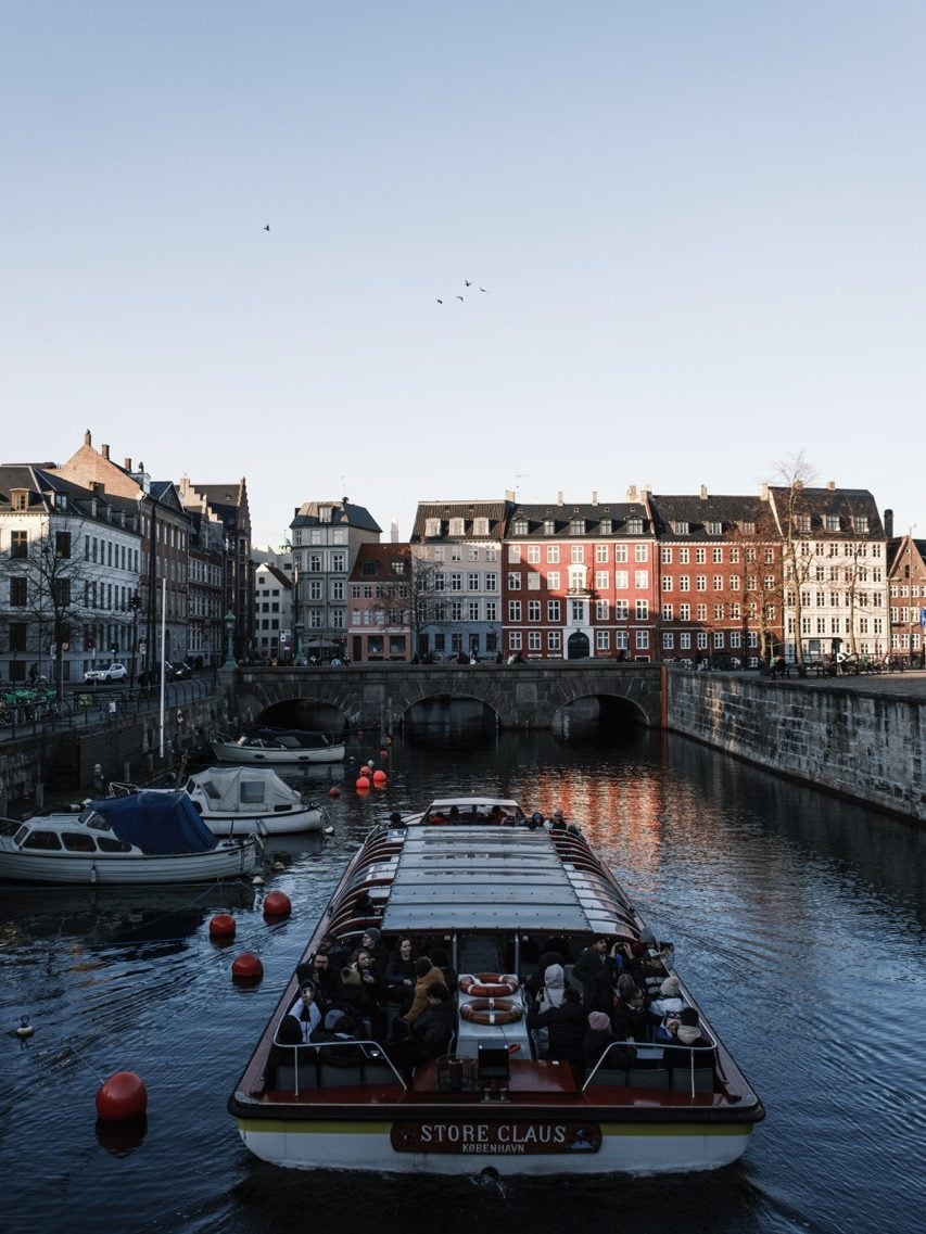 A boat going along a bridge in Copenhagen