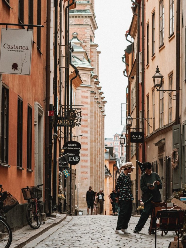 Two people reading a book outside a shop in Gamla Stan, Stockholm