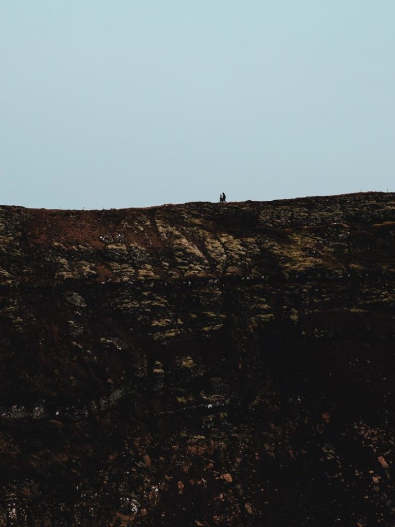 A couple hiking around Kerid Crater in Iceland