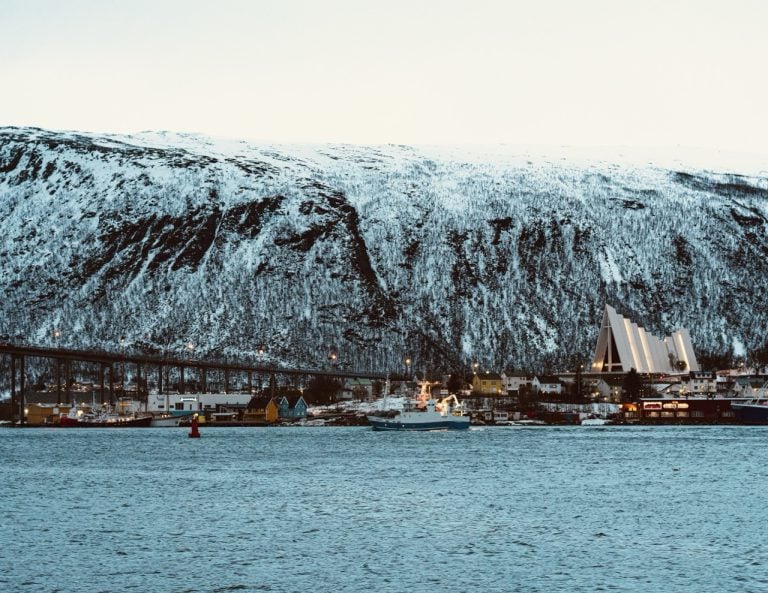 A boat in Tromsø, Norway, passing through the fjord in winter