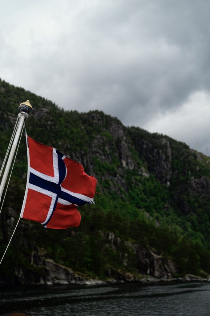 A Norwegian flag on a fjord cruise